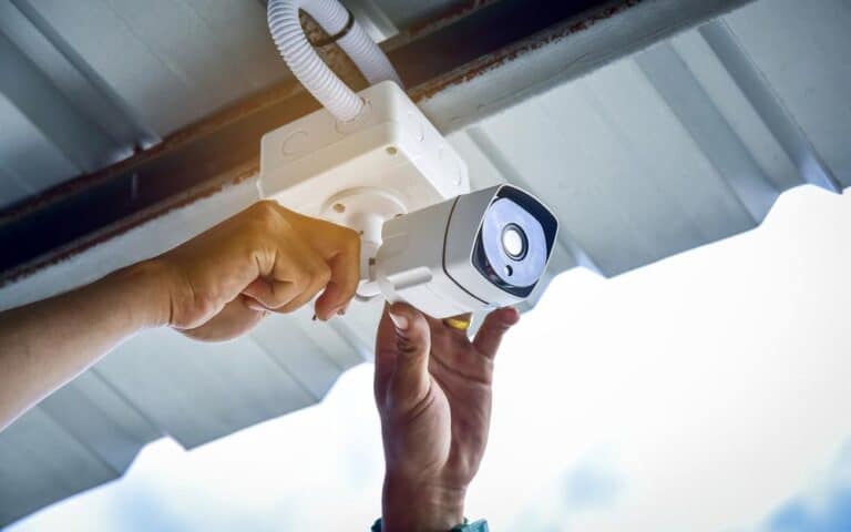 Man Installing A Security Camera