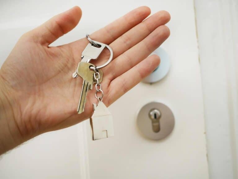 Woman Holding A Key To A House